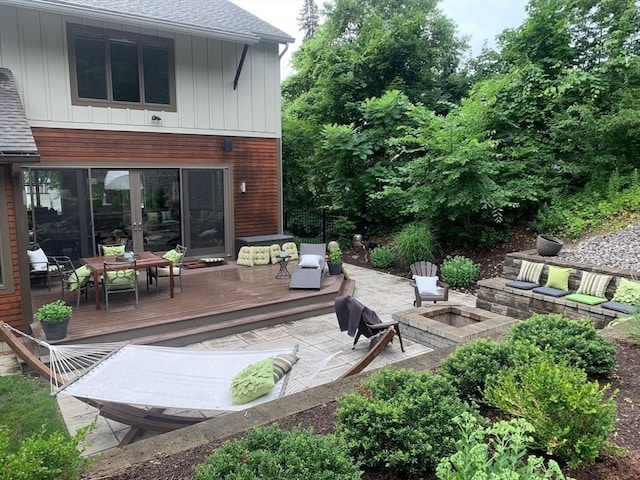 view of patio / terrace featuring an outdoor fire pit and a deck