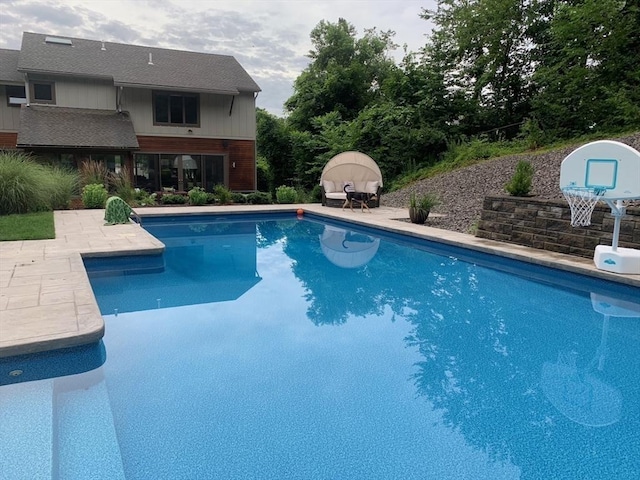 view of pool featuring a fire pit and a patio