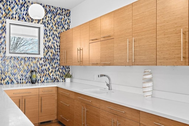 kitchen with sink, decorative light fixtures, and decorative backsplash