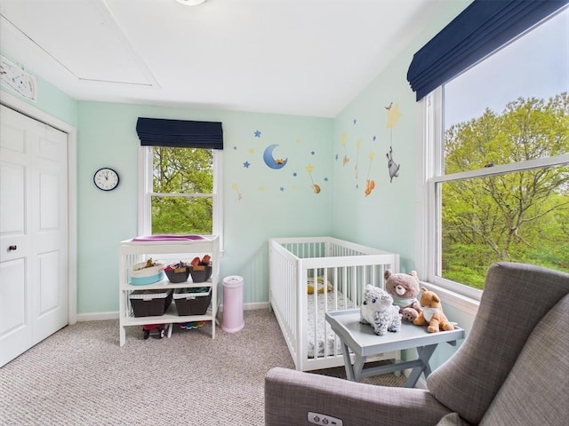 carpeted bedroom with multiple windows, a nursery area, and baseboards