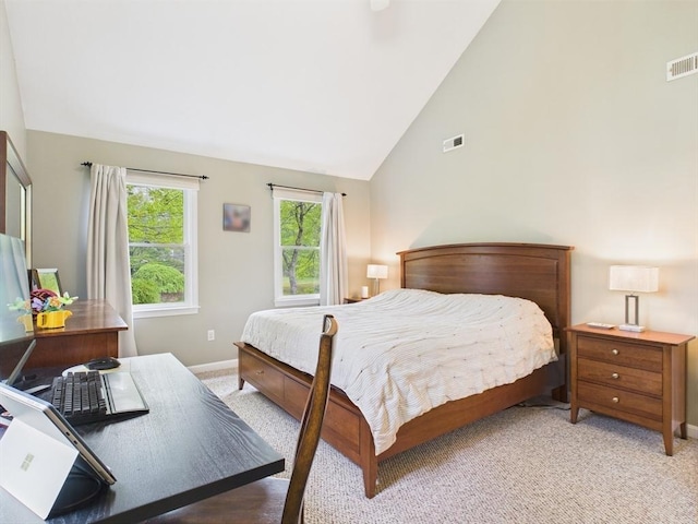 bedroom with light colored carpet, baseboards, and high vaulted ceiling