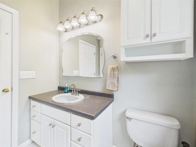 half bathroom with toilet and vanity