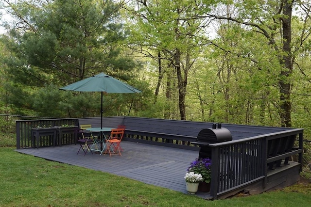 deck with a yard and outdoor dining space
