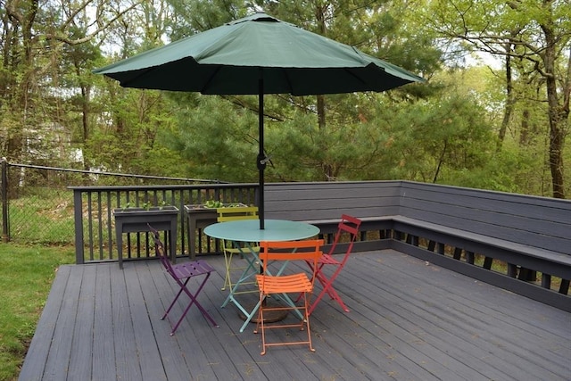 wooden terrace featuring outdoor dining area