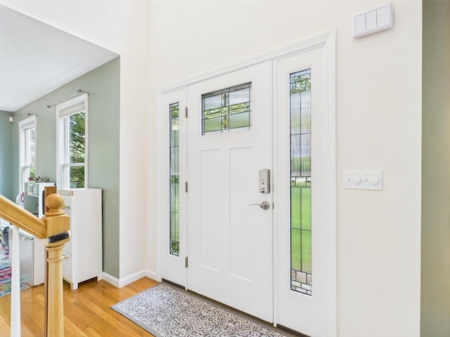 entrance foyer with light wood-style floors and baseboards