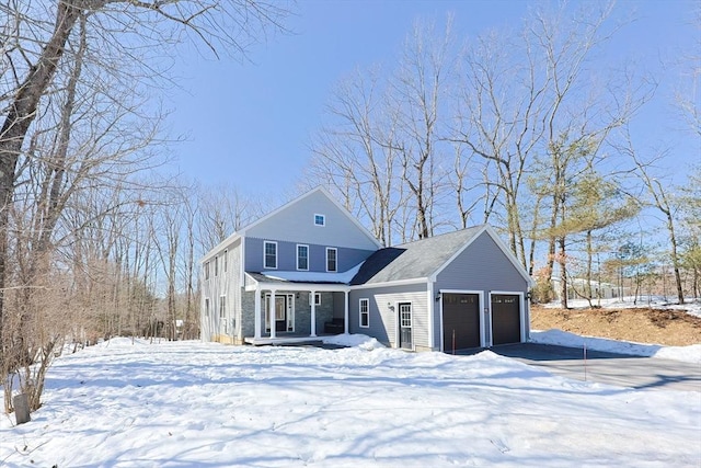 view of front of home featuring a porch and a garage