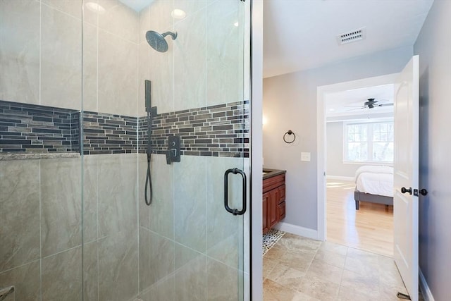 ensuite bathroom with visible vents, ensuite bathroom, a shower stall, vanity, and baseboards