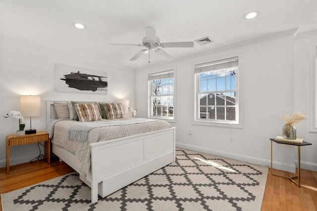 bedroom featuring ceiling fan, ornamental molding, and light hardwood / wood-style floors