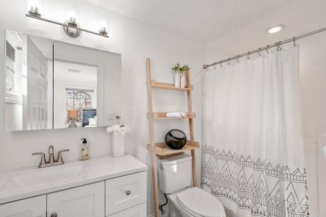 bathroom featuring vanity, a shower with curtain, and toilet