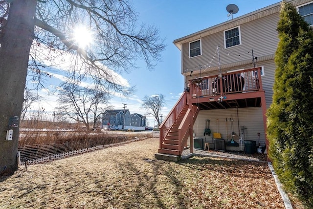 rear view of property featuring central AC unit and a deck