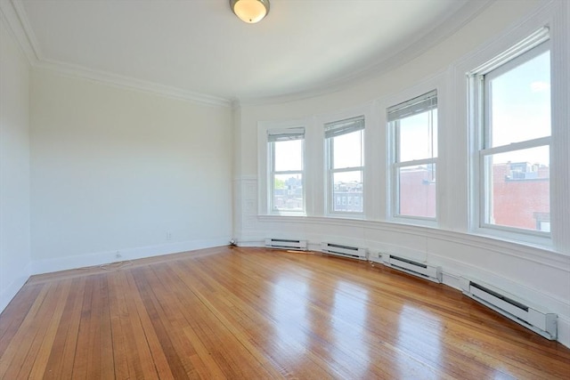 857 Beacon St Unit 51, Boston, MA 02215 - spare room featuring ornamental molding, light wood-style floors, baseboards, and a baseboard heating unit