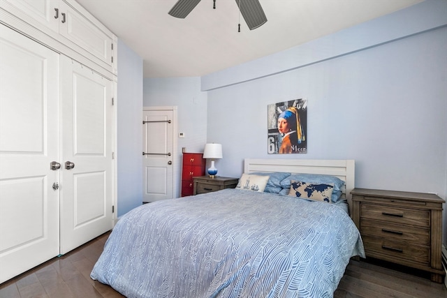 bedroom featuring dark hardwood / wood-style flooring, ceiling fan, and a closet