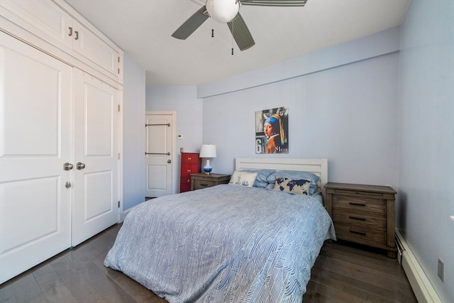 bedroom with ceiling fan, dark wood-type flooring, a closet, and a baseboard radiator