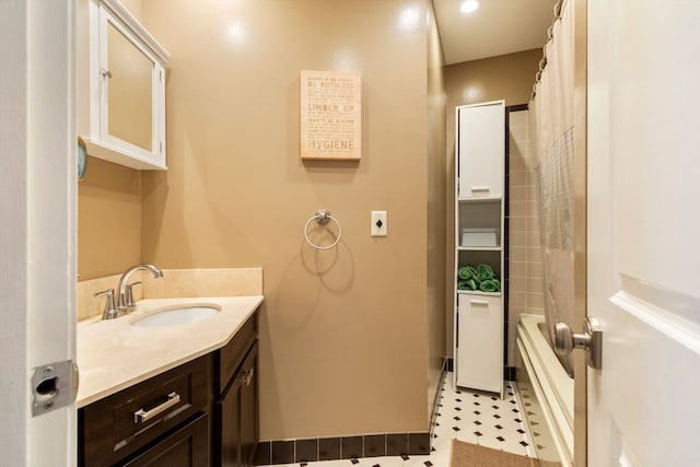 bathroom featuring shower / tub combo with curtain, vanity, and tile patterned flooring