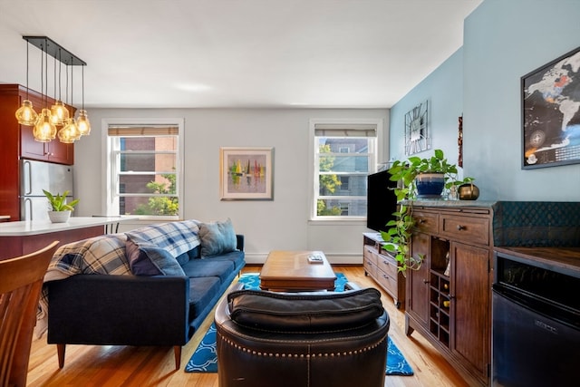 living room with light hardwood / wood-style floors and a baseboard radiator