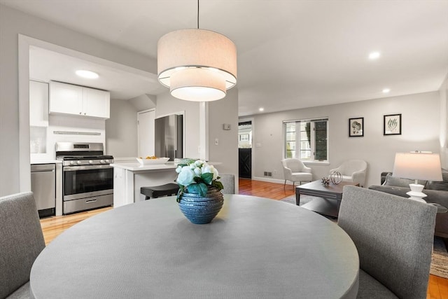 dining room with light hardwood / wood-style floors