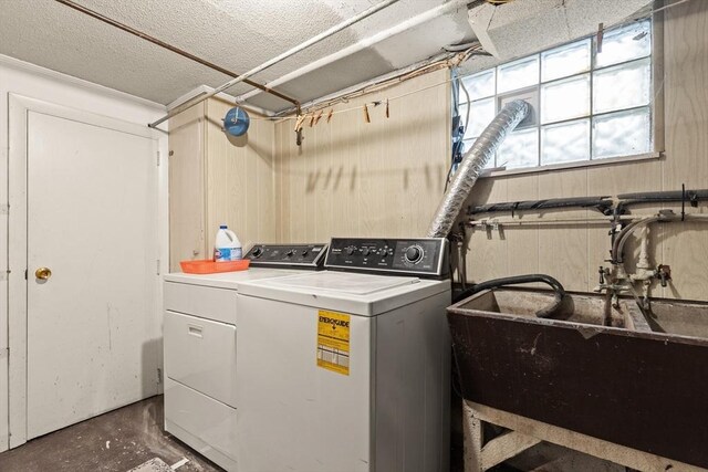 clothes washing area with washer and dryer and sink