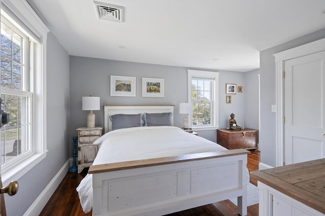 bedroom featuring dark wood-type flooring and baseboards
