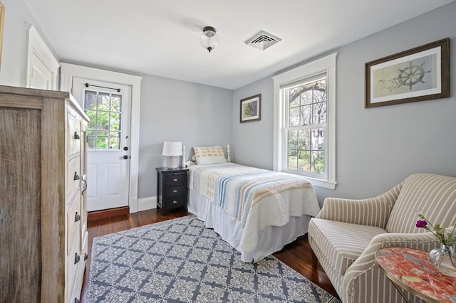 bedroom featuring dark wood finished floors and baseboards