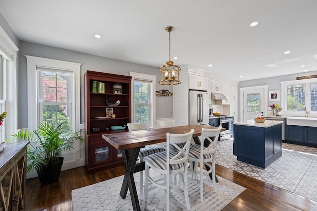dining area with plenty of natural light, a chandelier, wood finished floors, and recessed lighting