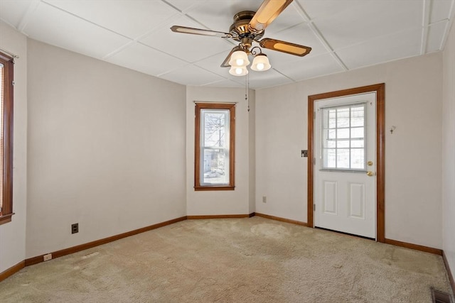 interior space with light carpet, visible vents, ceiling fan, and baseboards