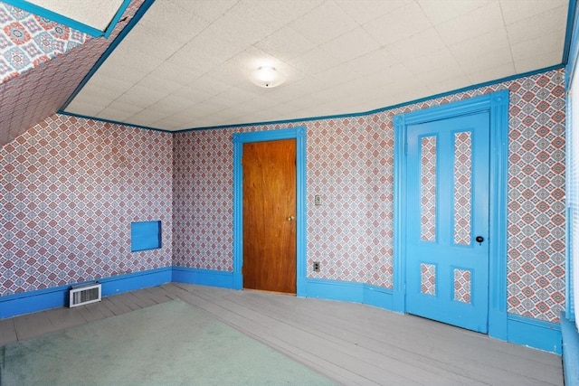 interior space featuring wallpapered walls and visible vents