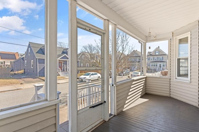 unfurnished sunroom featuring a residential view