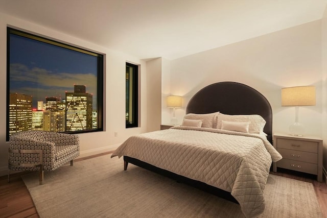 bedroom with baseboards and wood finished floors