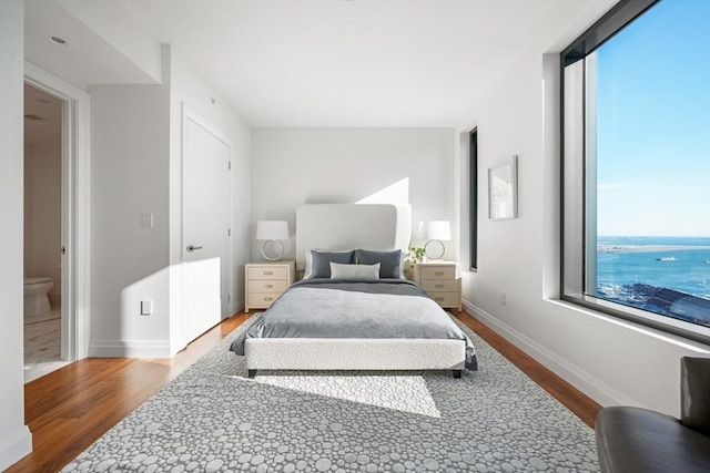 bedroom featuring baseboards and wood finished floors