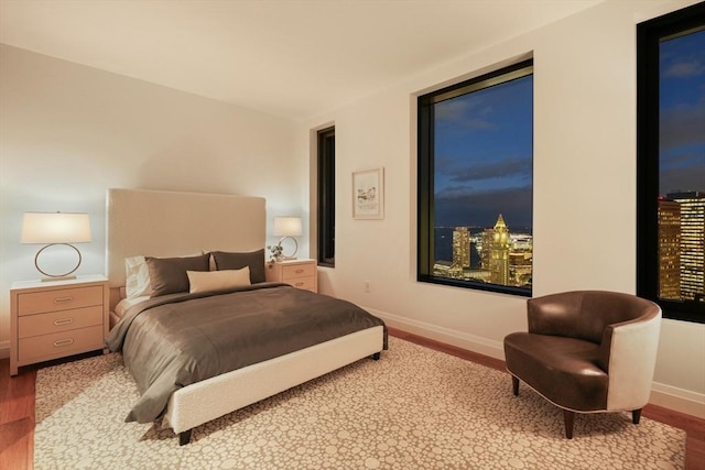 bedroom with wood finished floors and baseboards