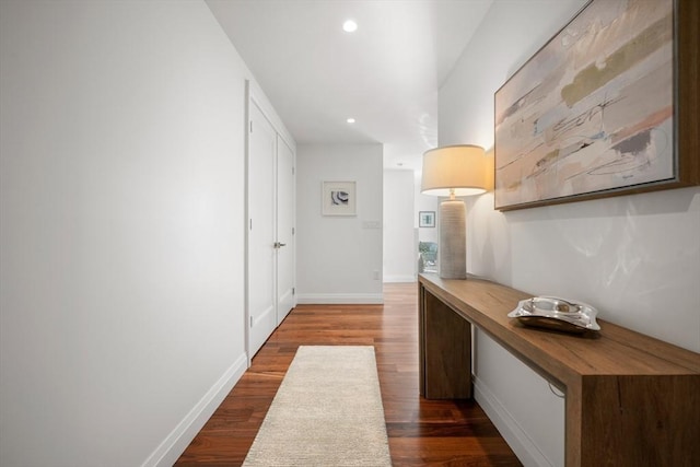 hallway with recessed lighting, dark wood-style flooring, and baseboards