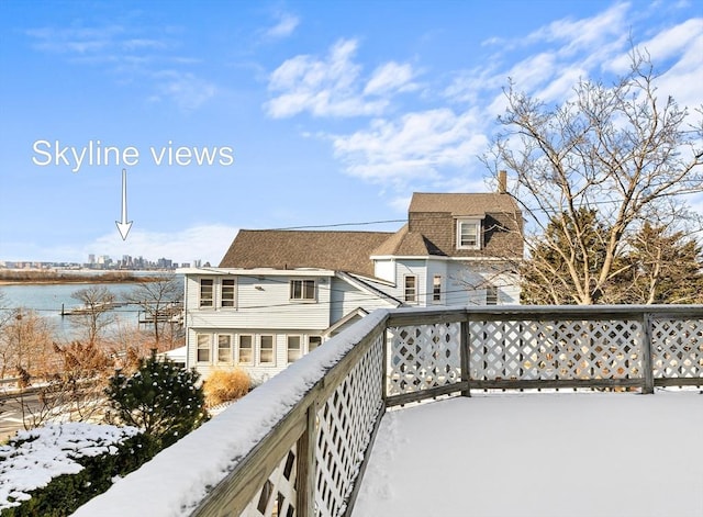 view of snow covered back of property