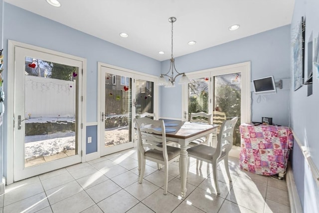 tiled dining space with an inviting chandelier