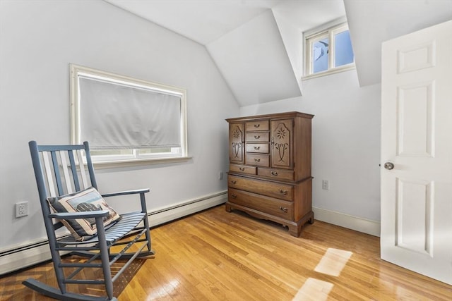 sitting room featuring lofted ceiling, hardwood / wood-style floors, and a baseboard radiator