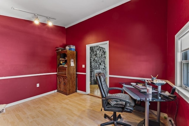 office area with hardwood / wood-style floors, track lighting, and ornamental molding