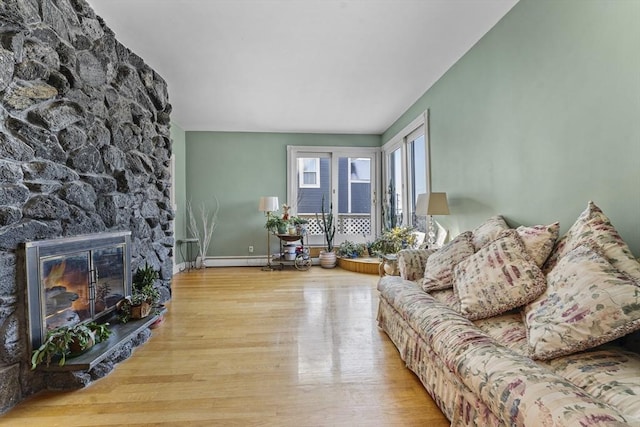 living room with a fireplace and light wood-type flooring