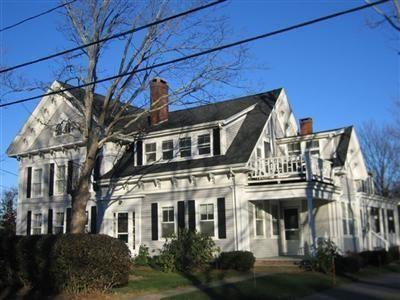 24 Church St Unit A, Dennis, MA 02670 - view of front facade featuring a chimney and a balcony
