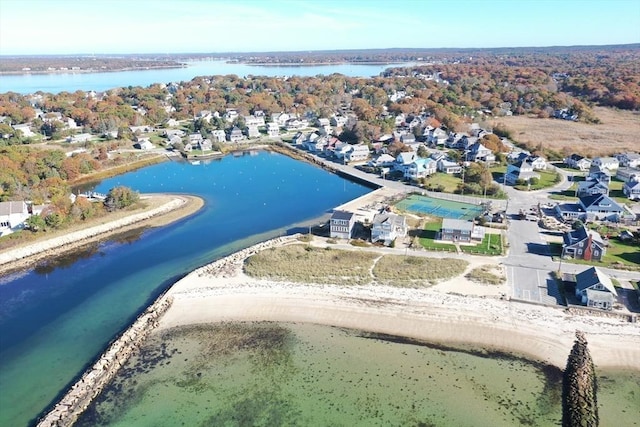 birds eye view of property with a water view and a view of the beach