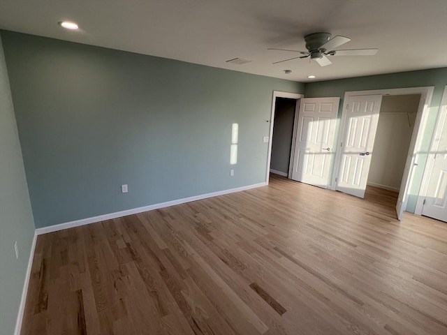 unfurnished bedroom with ceiling fan, light wood-type flooring, and a closet