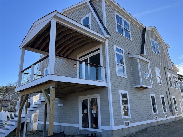 back of house featuring a balcony