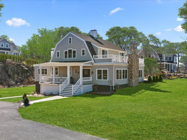 view of front of house with a front yard and covered porch