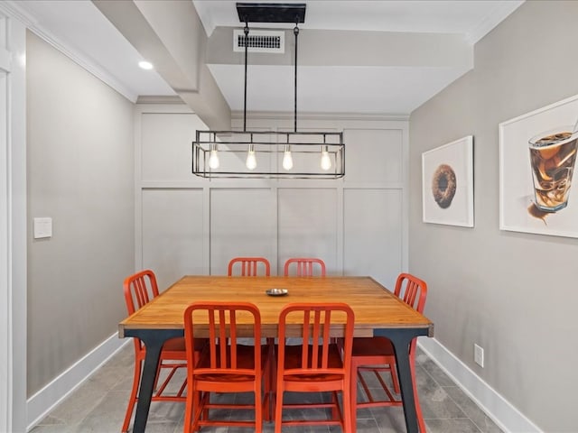 dining space with ornamental molding