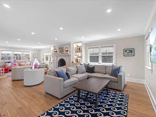 living room featuring light hardwood / wood-style flooring and ornamental molding