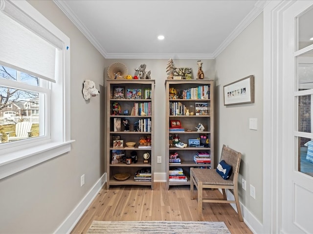 sitting room featuring light wood-type flooring and crown molding