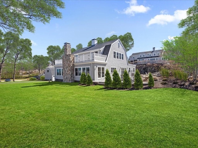 572 Jerusalem Rd, Cohasset, MA 02025 - back of property with a balcony, a yard, a gambrel roof, and a chimney