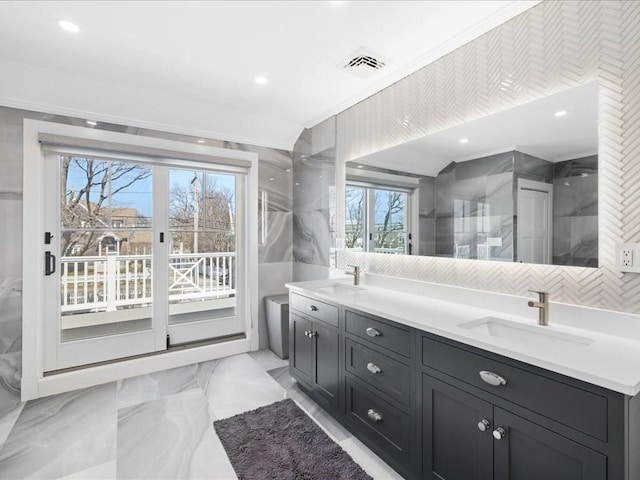 572 Jerusalem Rd, Cohasset, MA 02025 - full bathroom with plenty of natural light, tile walls, crown molding, double vanity, and marble finish floors