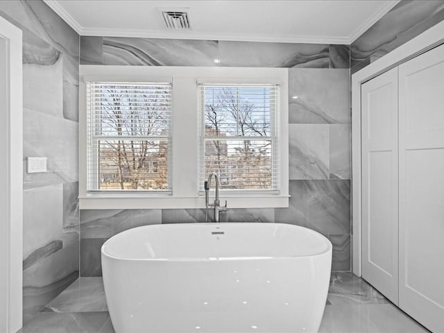 572 Jerusalem Rd, Cohasset, MA 02025 - full bathroom with crown molding, marble tiled floors, tile walls, plenty of natural light, and a soaking tub