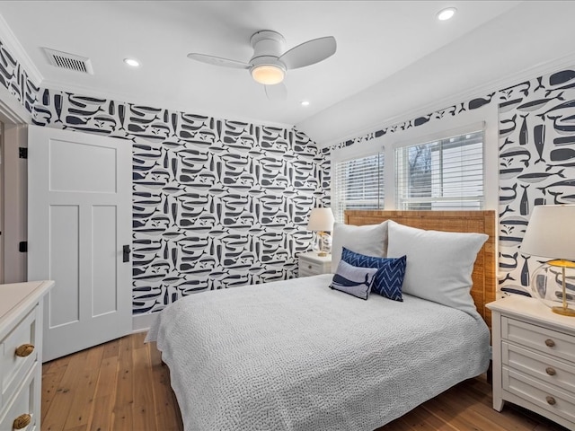 bedroom featuring hardwood / wood-style floors, ceiling fan, and lofted ceiling