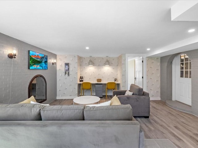 572 Jerusalem Rd, Cohasset, MA 02025 - living area featuring wood finished floors, a glass covered fireplace, arched walkways, baseboards, and recessed lighting