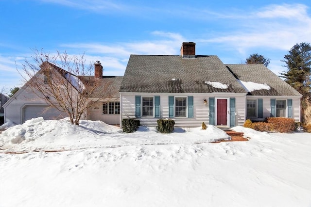 new england style home featuring a shingled roof and a chimney